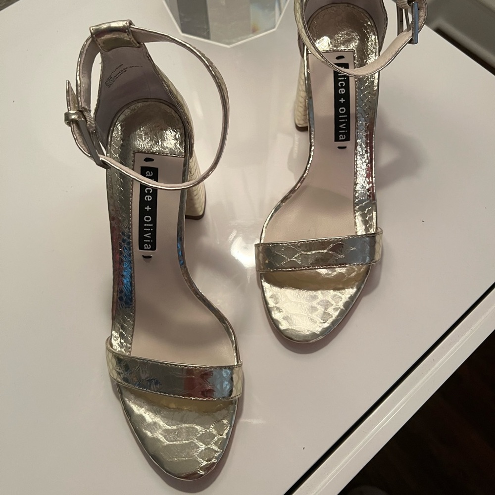 Brand new Alice and Olivia, gold sandal with ankle strap and 3” heel. Size 8